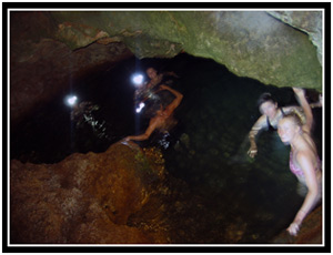 Testing the dark waters of a cave in Baracoa (25k image)
